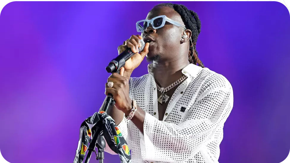 Artist performing on purple stage