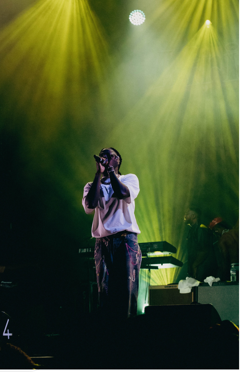 Performer under green stage lights
